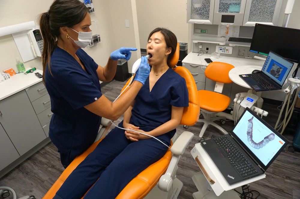 Maxillary scan alternate positioning — seated, pointing to guide the scan